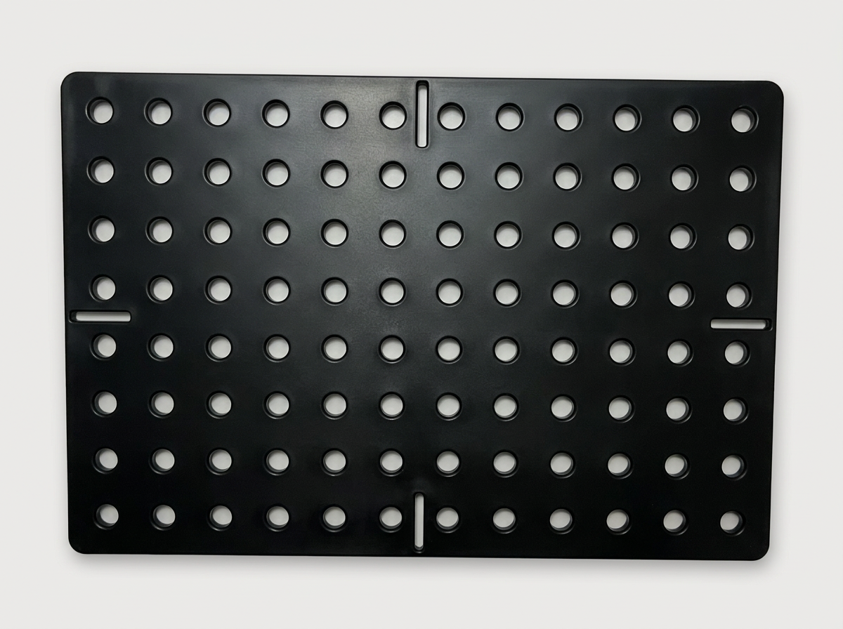 Black HDPE panel with a custom grid of holes and edge slots